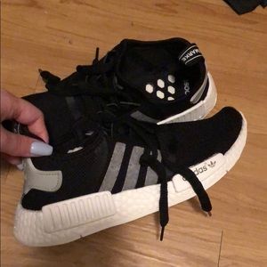 Black woman’s NMDs Adidas